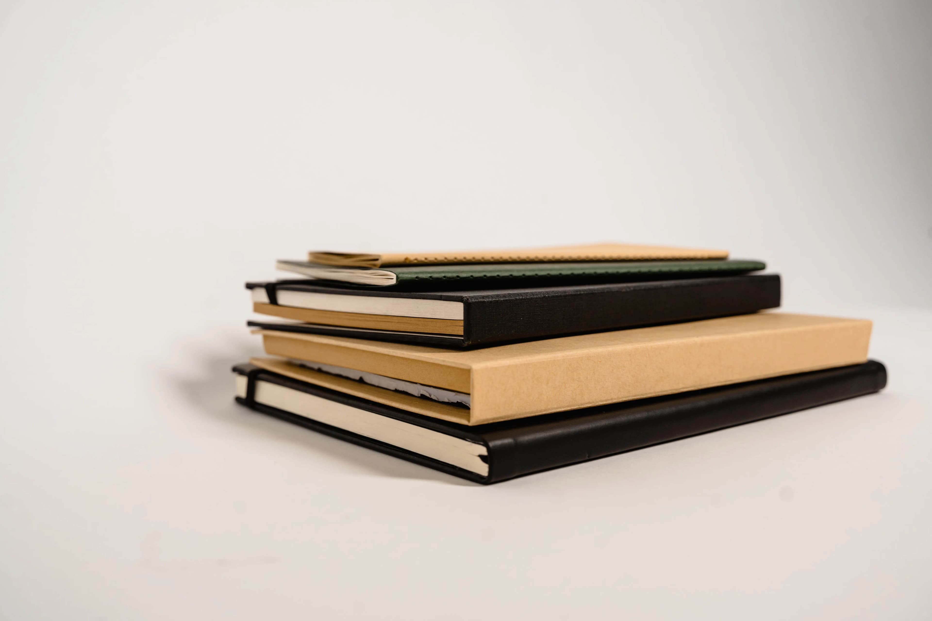 A stack of notebooks with different cover textures